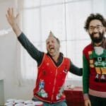 Wspólna impreza integracyjna pracowników w biurze w świątecznych swetrach